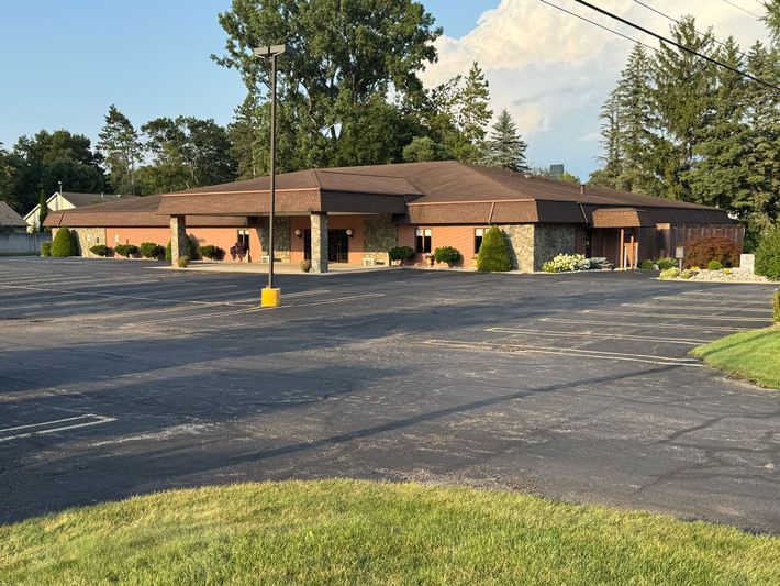 Allen Mortuary staff with hearse in parking lot in Logan, UT