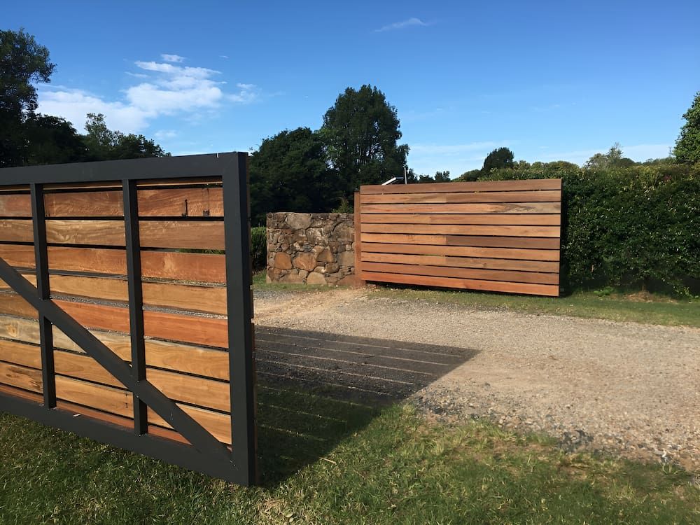 A Wooden Gate Is Open To A Dirt Road — Brunswick Valley Door Centre in Main Arm, NSW