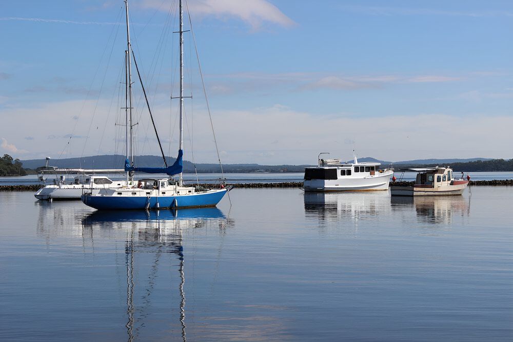 A Group Of Boats Are Docked In A Body Of Water — Brunswick Valley Door Centre in Northern Rivers, NSW