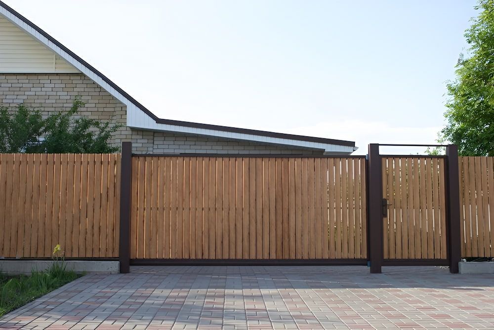 A Wooden Fence With A Gate In Front Of A House — Brunswick Valley Door Centre in Main Arm, NSW