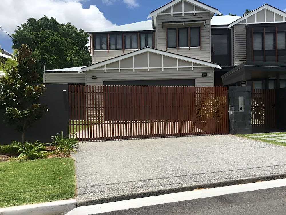 A House With A Sliding Gate In Front Of It — Brunswick Valley Door Centre in Main Arm, NSW
