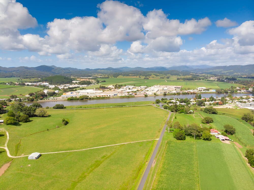 An Aerial View Of A Lush Green Field With A River — Brunswick Valley Door Centre in Murwillumbah, NSW