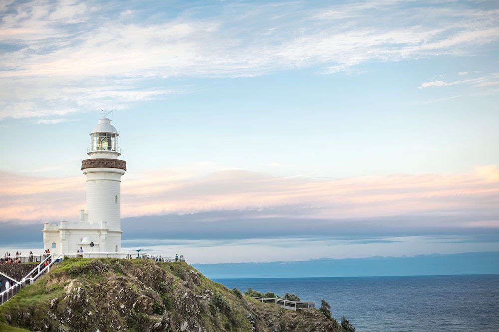 A Lighthouse Is Sitting On Top Of A Cliff Overlooking The Ocean — Brunswick Valley Door Centre in Byron Bay, NSW