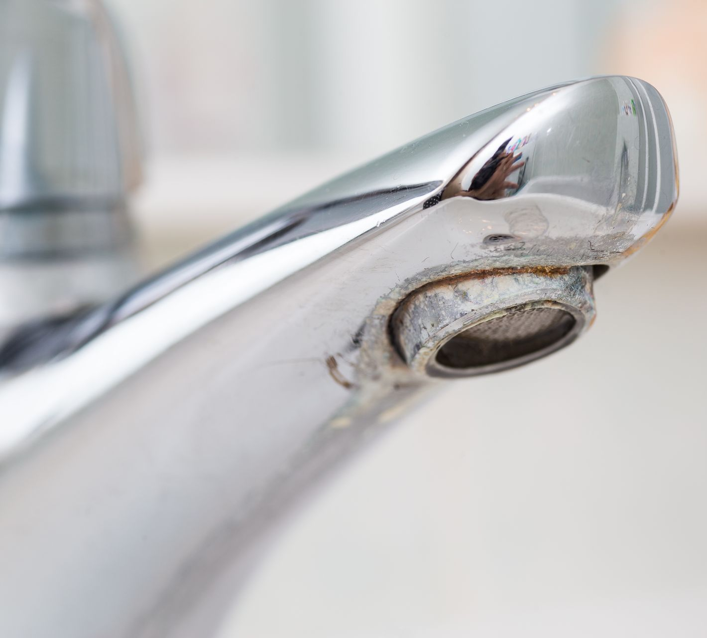 A close up of a faucet with water running out of it.
