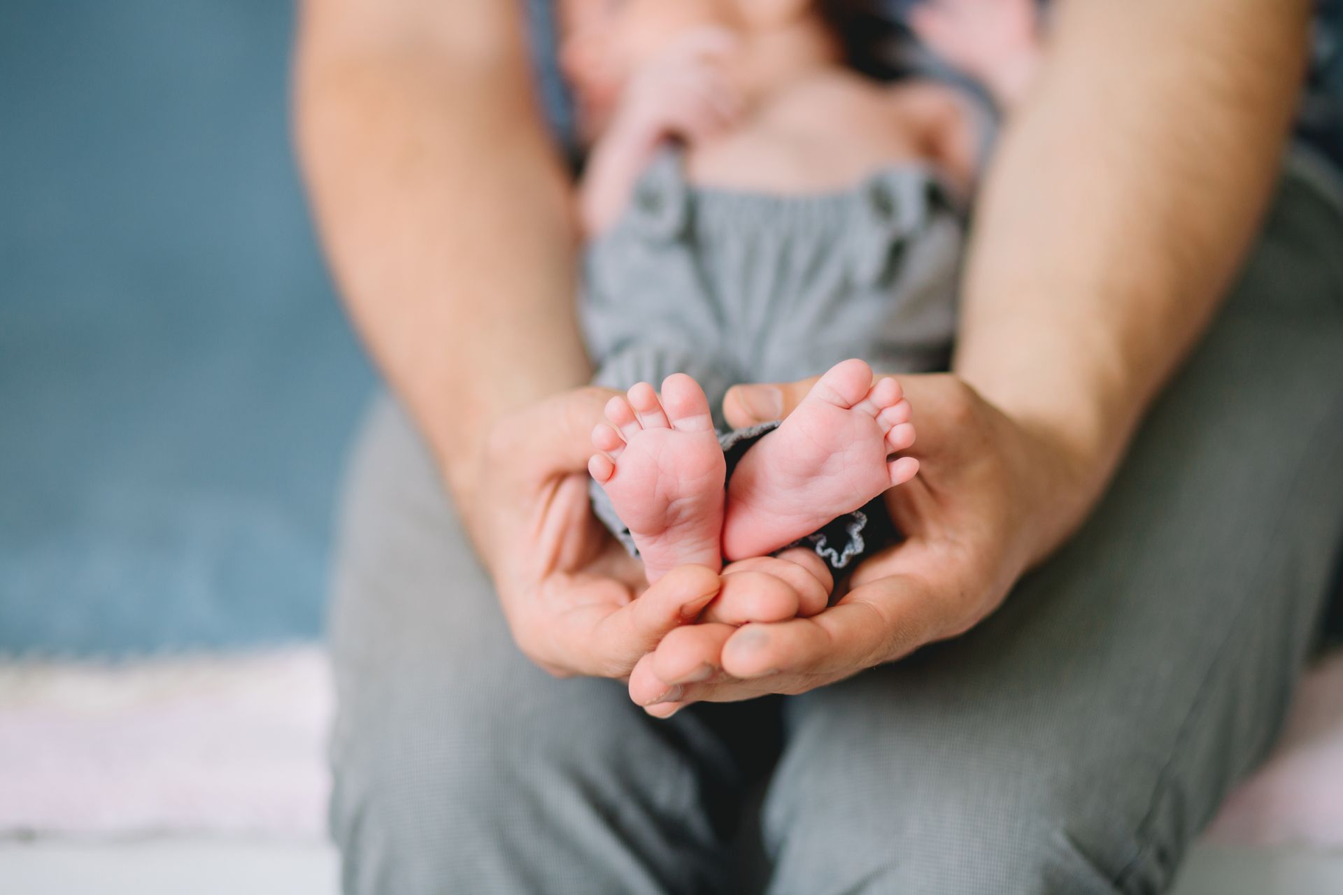 A person is holding a baby 's feet in their hands.
