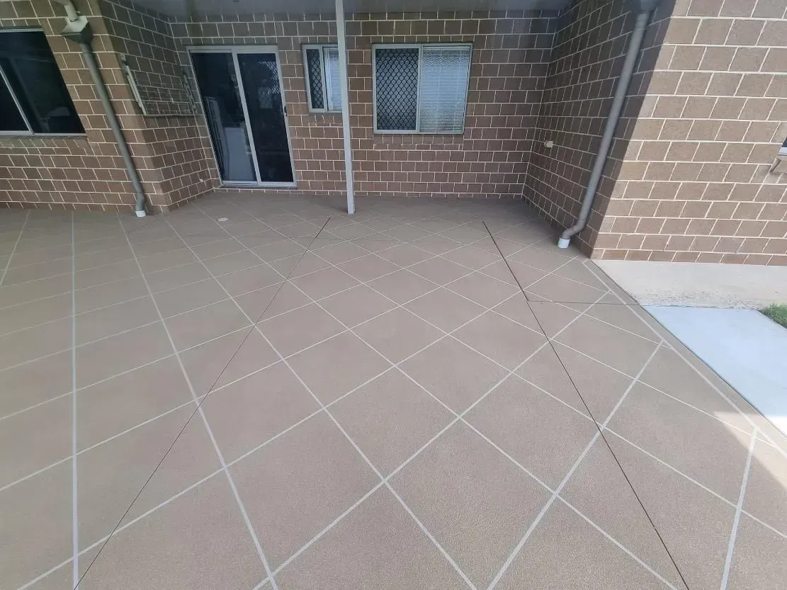 Outdoor Patio With Diamond-patterned Tiles, Brick Walls, a Sliding Glass Door, and a Window — SRS Concreting In Kingaroy, QLD