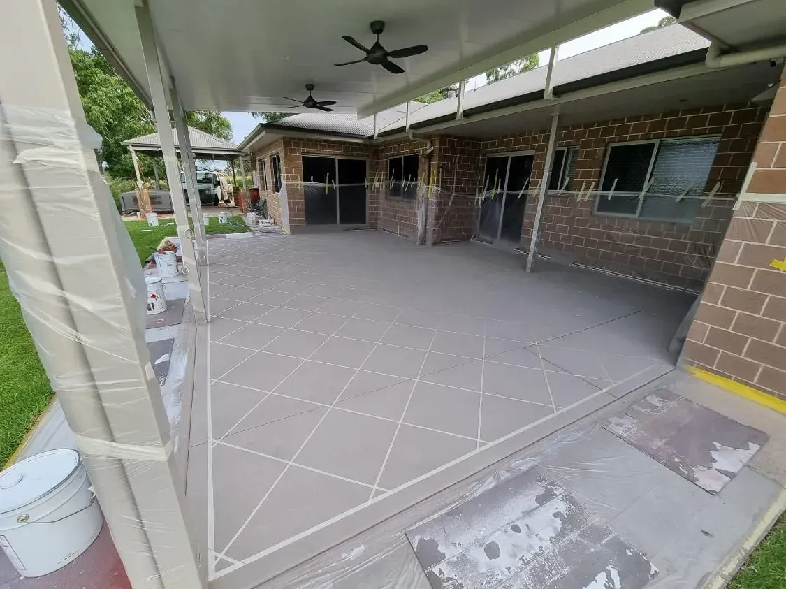 Covered Patio With Grey Tiled Floor, Brick Walls, and Ceiling Fans — SRS Concreting In Kingaroy, QLD