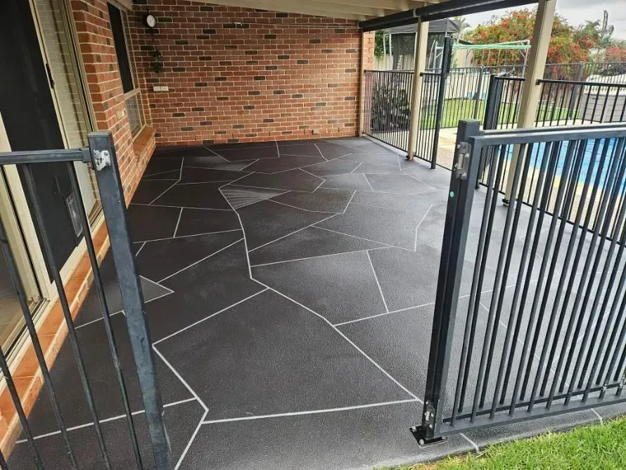 Black Patio With Stone-like Design, Enclosed by Black Metal Fence — SRS Concreting In Highfields, QLD