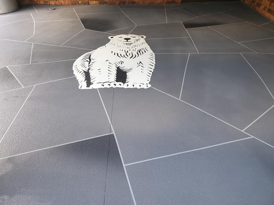 White Polar Bear Stencil on Grey Flagstone Patio — SRS Concreting In Glenvale, QLD