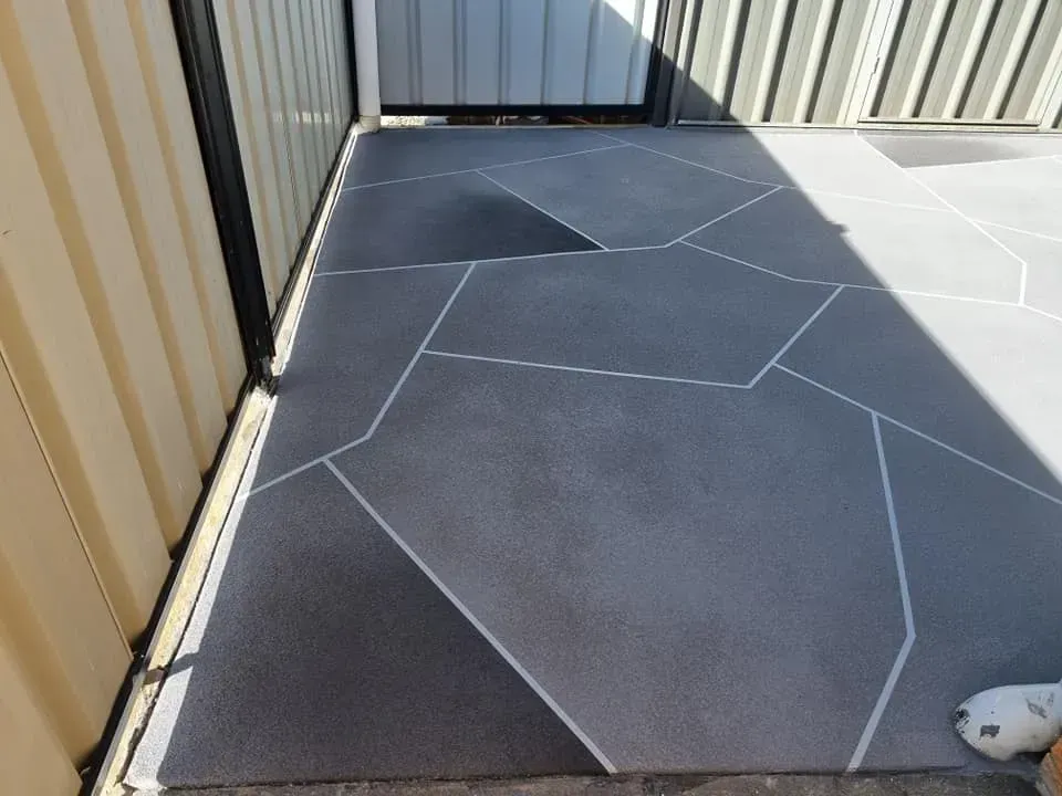 Grey Geometric Patio With White Lines, Between a Fence and Building — SRS Concreting In Glenvale, QLD
