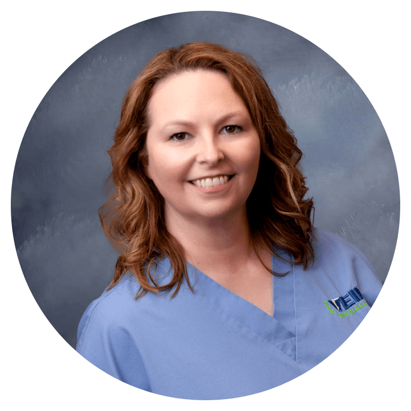 A woman wearing blue scrubs smiling in a circle