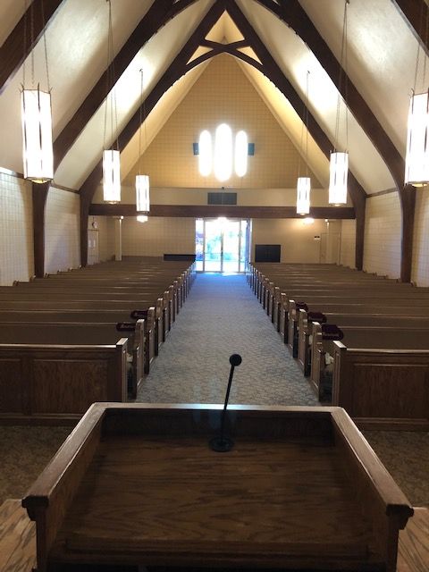 An empty church with a podium and a microphone