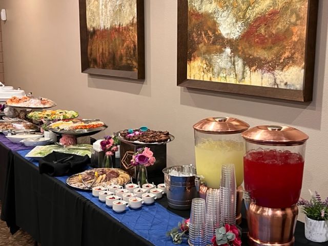 A buffet table with a variety of food and drinks on it.