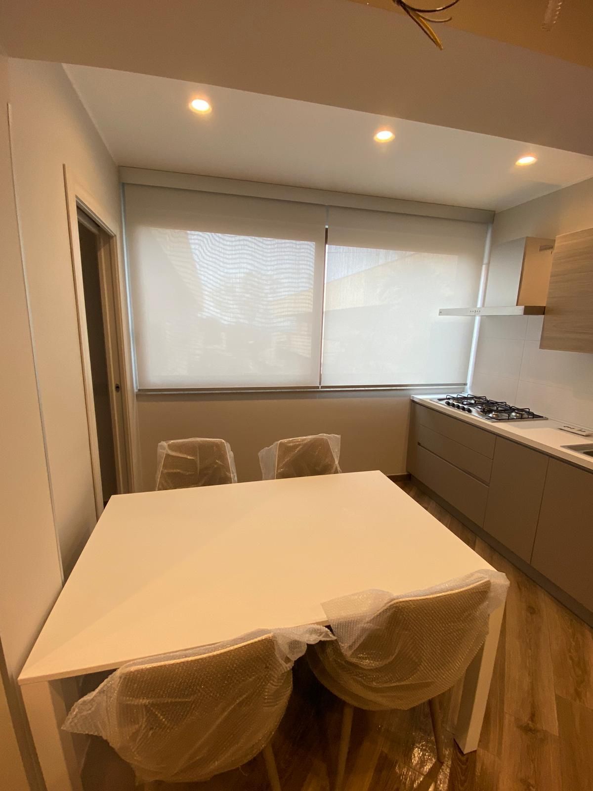 Una cucina con tavolo e sedie e una finestra