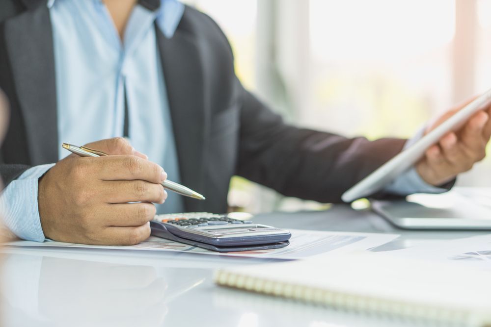 Businessperson calculating a start-up loan for a small business.