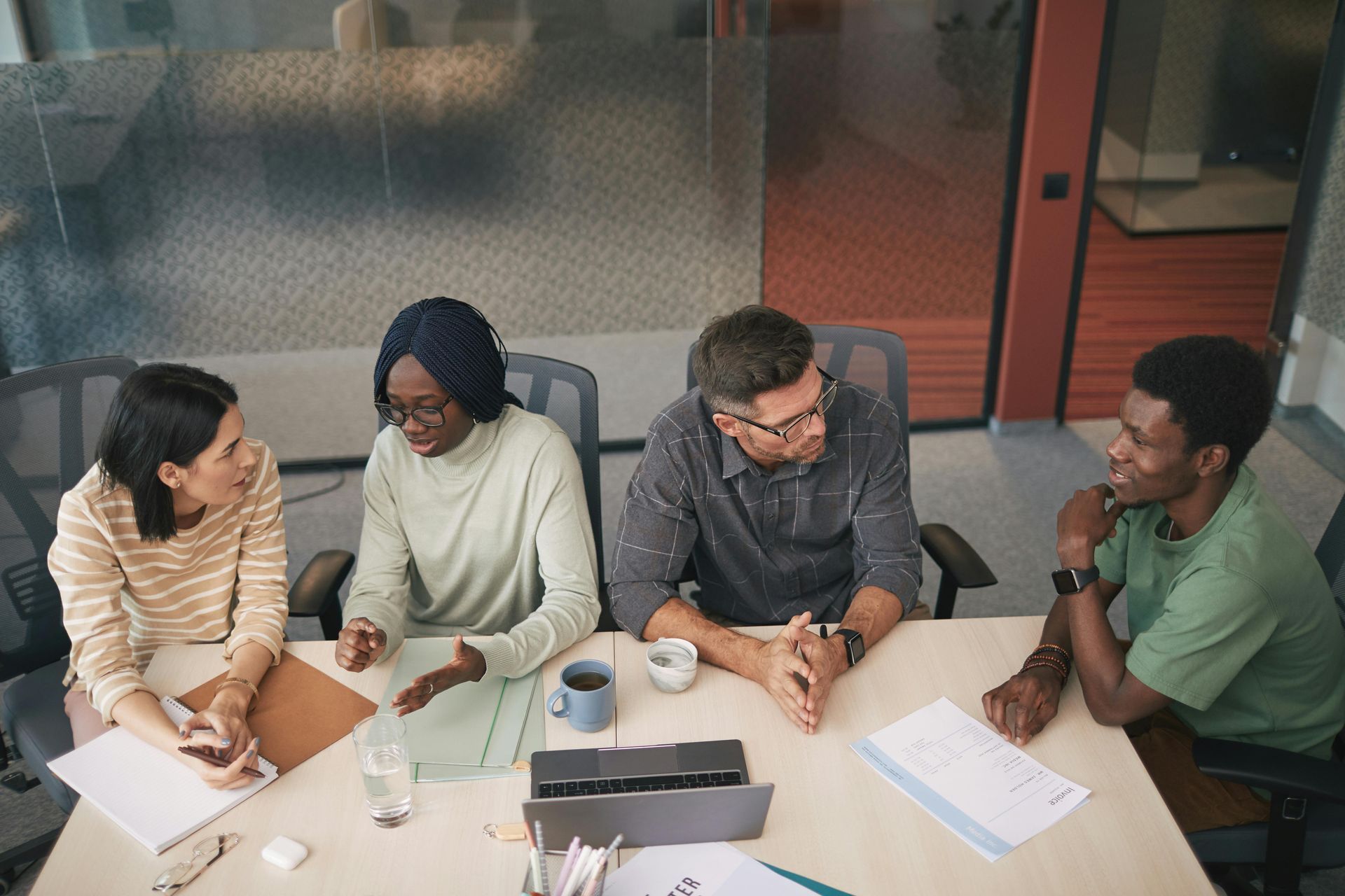 Diverse team strategizing on raising capital for startup at a business meeting.