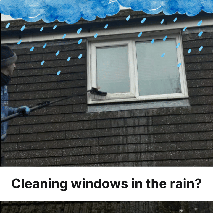 Person cleaning a window in the rain with a long-handled brush on a brown building with a white window frame and cloudy sky.
