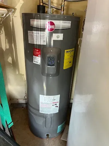 Gray Rheem water heater in a utility room.
