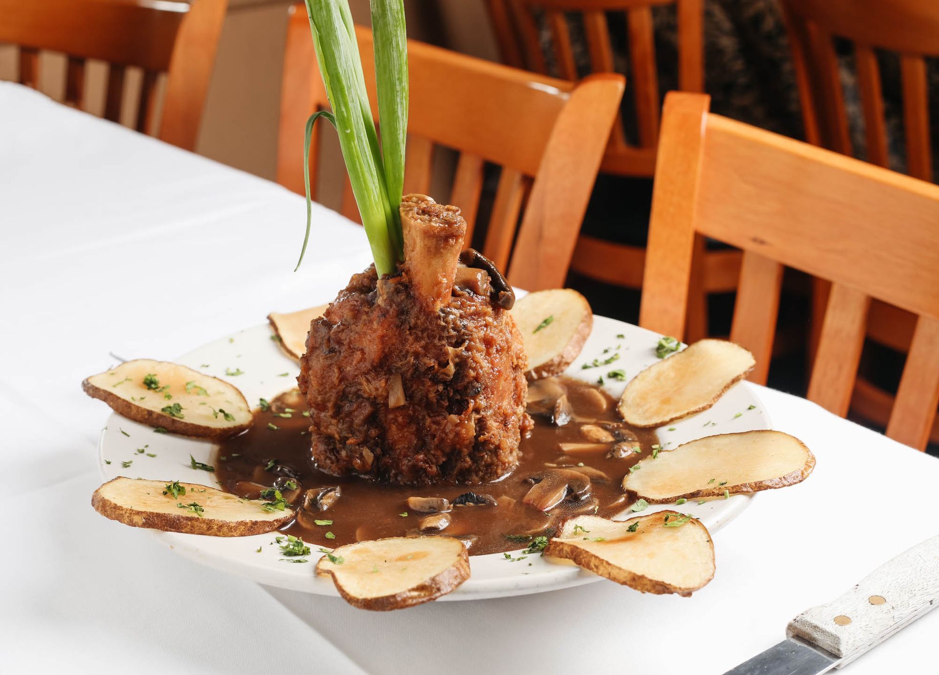 A plate of food with potatoes and gravy on a table