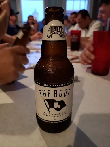 A bottle of the boot beer sits on a table