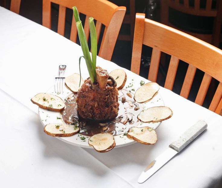 A plate of food with asparagus and potatoes on a table