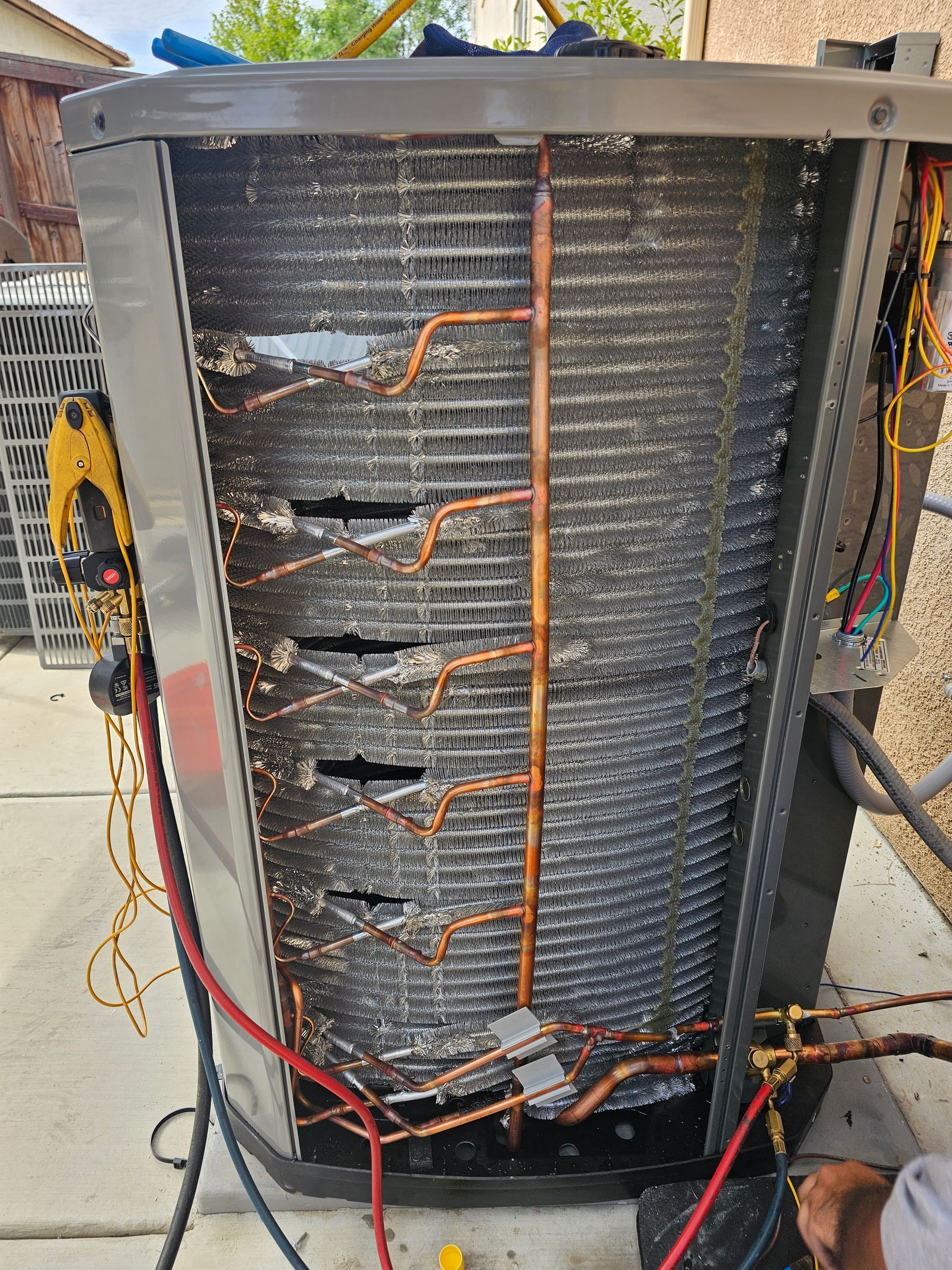 The inside of an air conditioner with a lot of wires coming out of it.