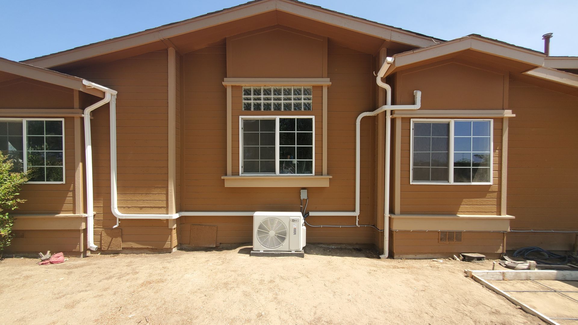 A house with a large air conditioner on the side of it