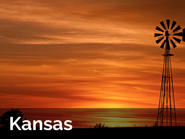 A picture of a windmill in kansas at sunset
