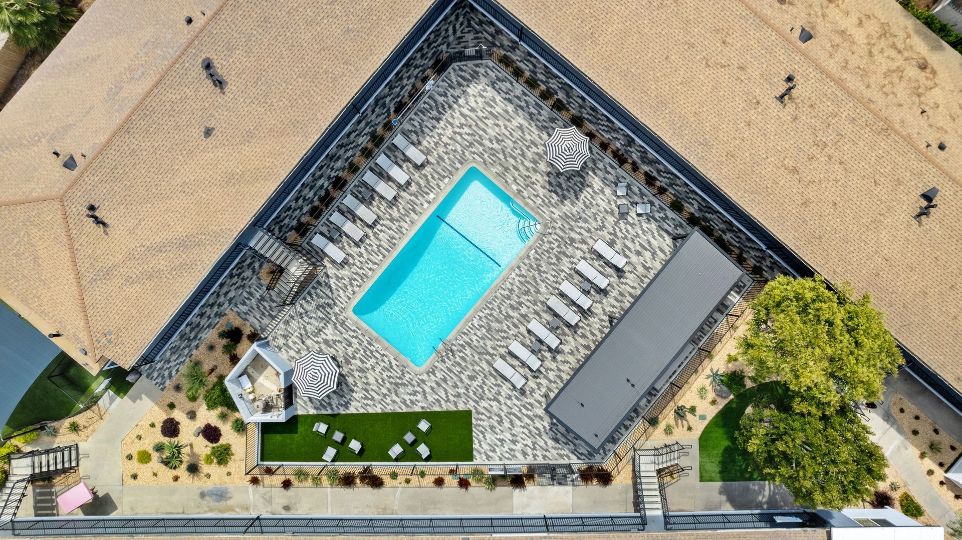 An aerial view of a swimming pool in a residential area