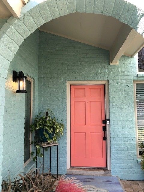 a pink door on a blue brick house | Corpus Christi, TX | GT Roofing