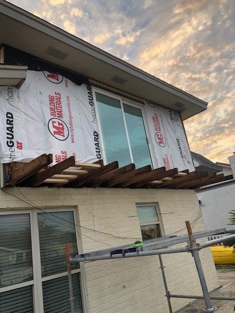 a house with a lot of windows is being remodeled .  | Corpus Christi, TX | GT Roofing