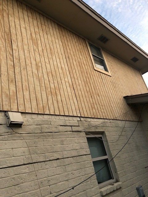 a house with a wooden siding and a window  | Corpus Christi, TX | GT Roofing