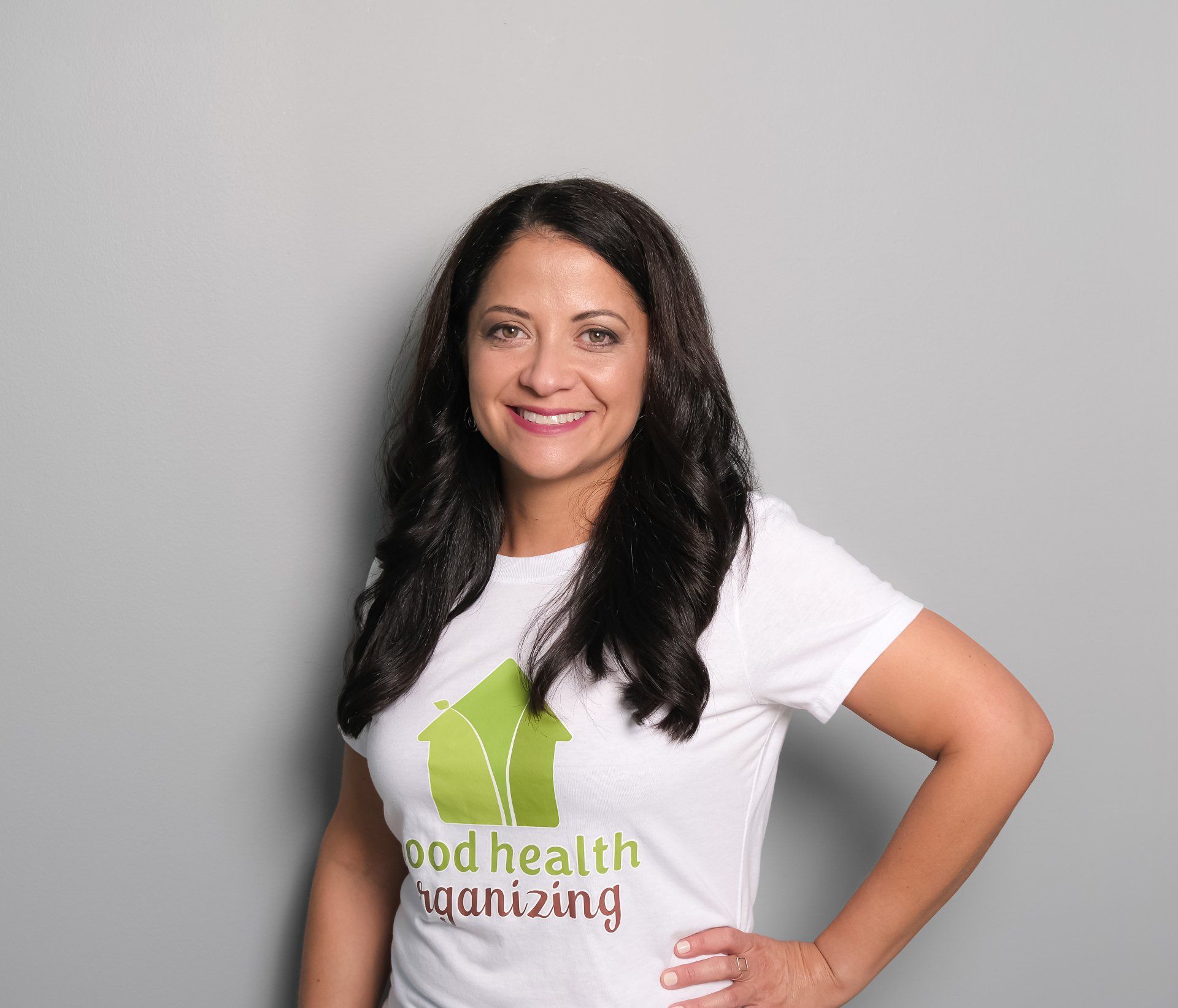 Dani wearing a white t-shirt that says good health organizing