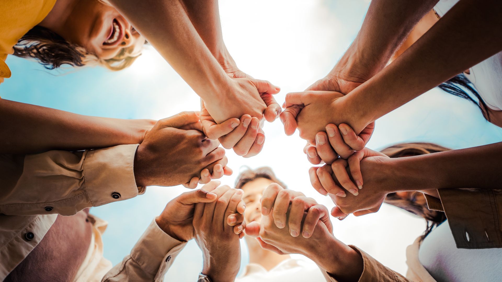 A pair of small, silver-toned metal scissors with ornate, embossed decorative handles.