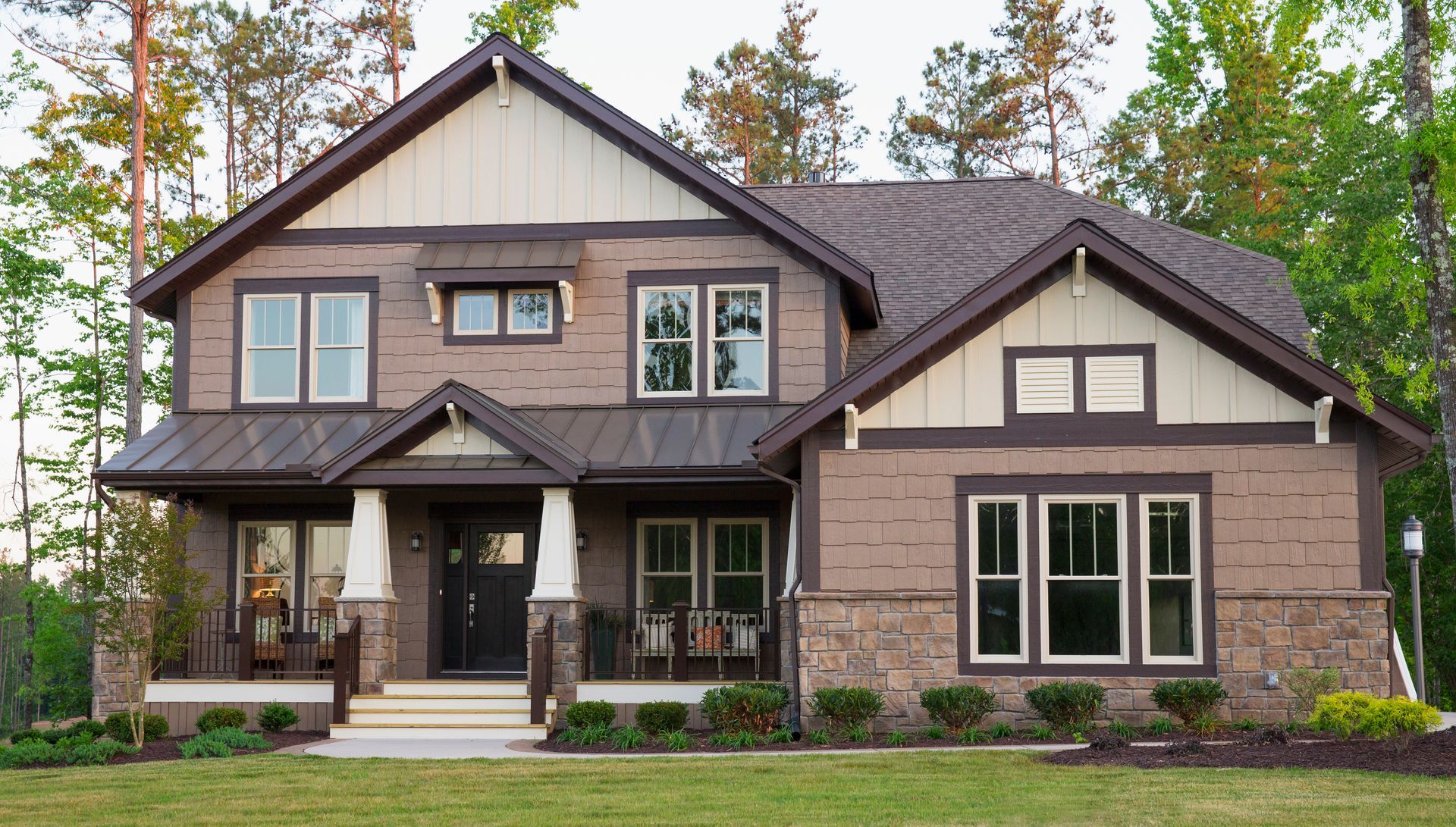 A large house with a lot of windows and trees in the background