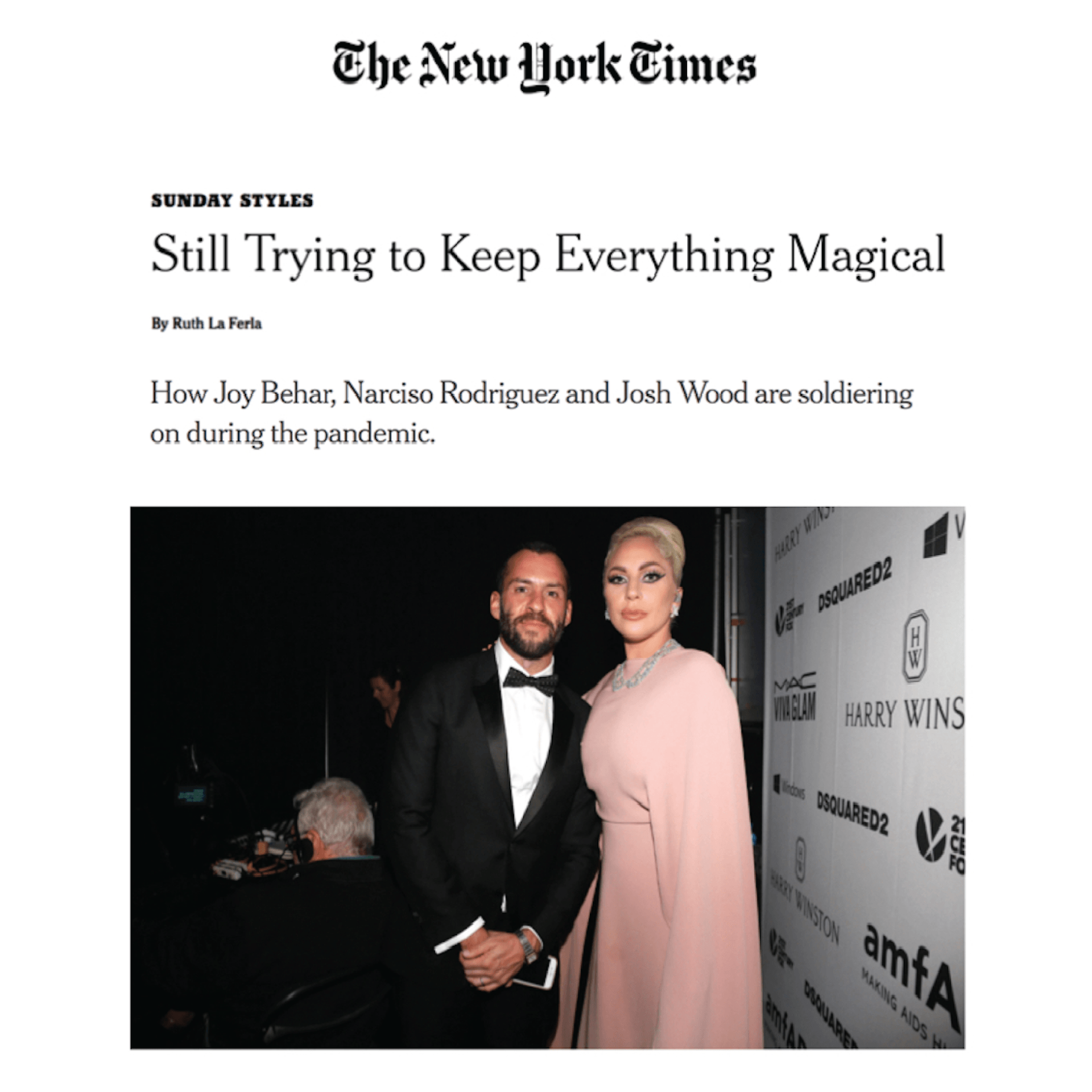 A man and a woman are standing next to each other on a red carpet.