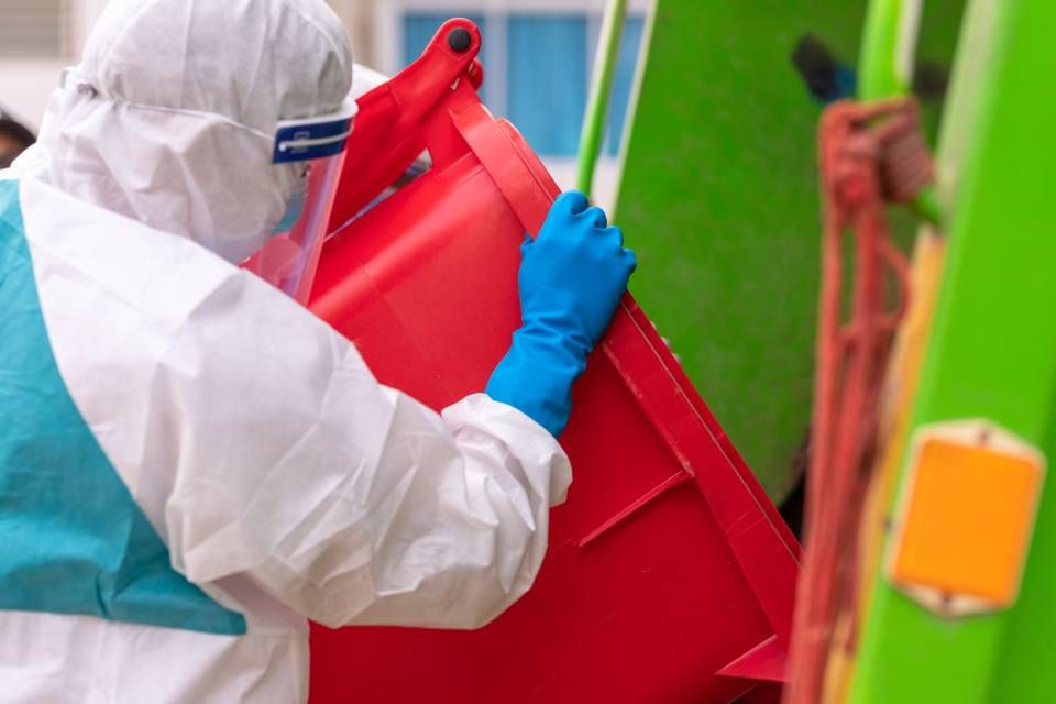 a man loading waste from dustbins