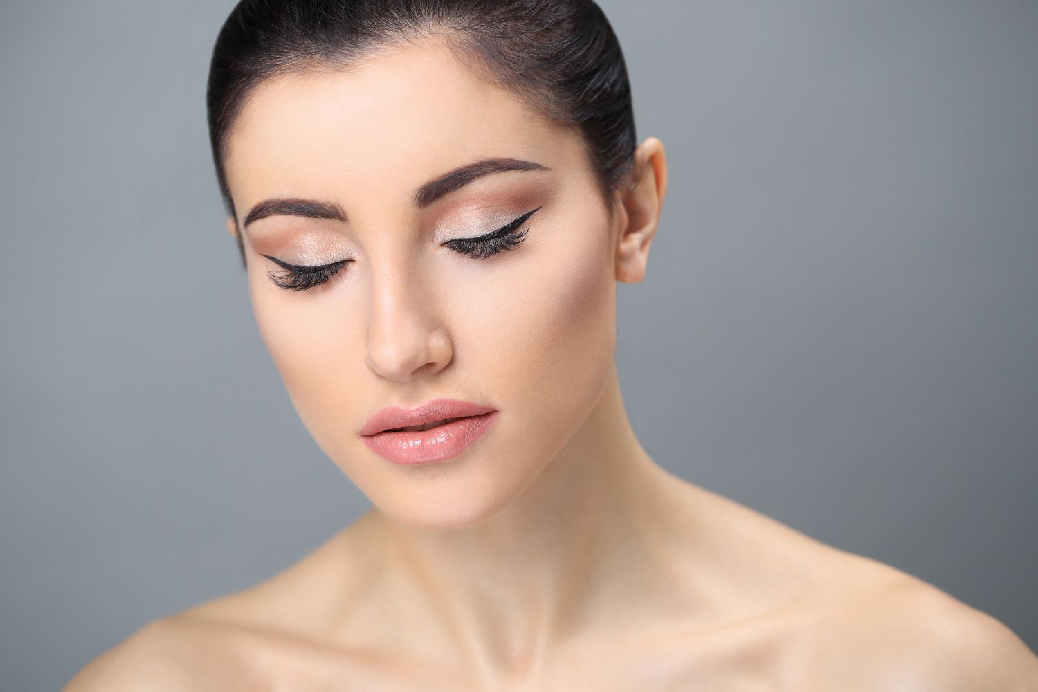 A close up of a woman 's face with her eyes closed.