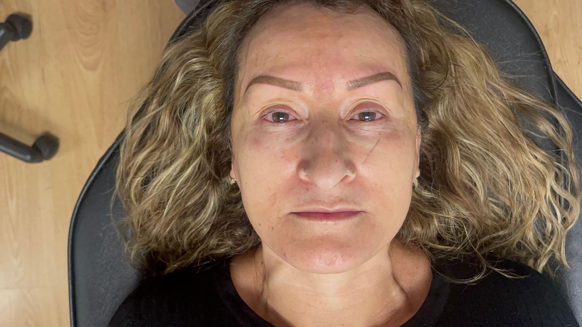 A woman is laying in a chair with her eyes closed.