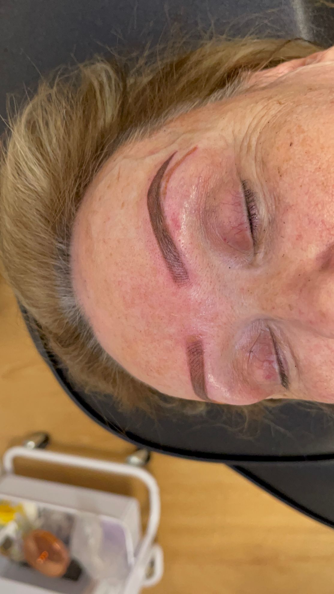 A close up of a woman 's face with her eyes closed.