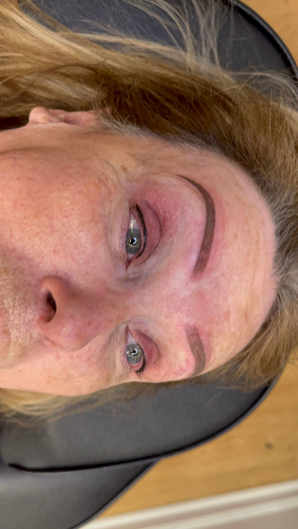 A close up of a woman 's face with her eyes closed.