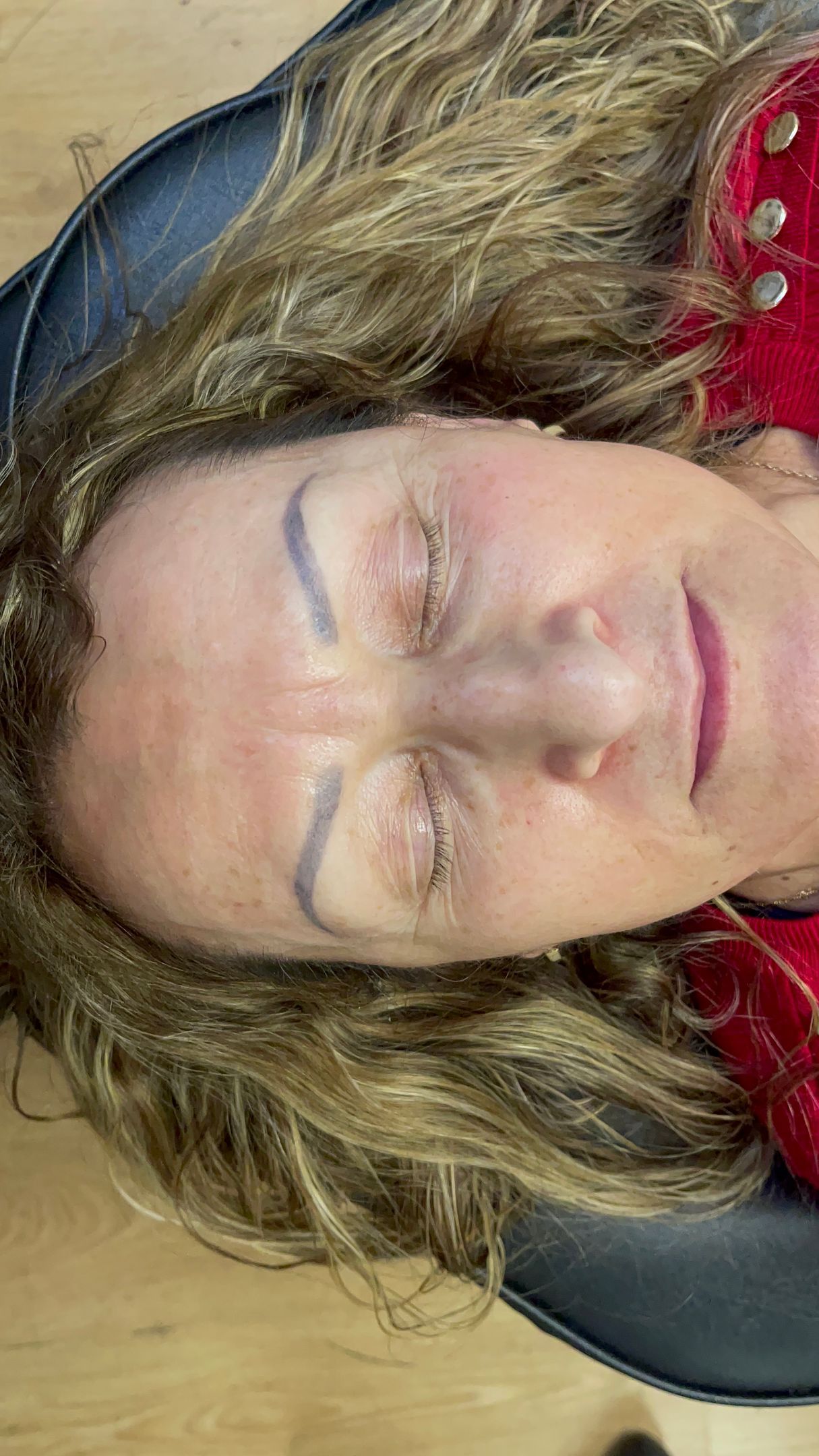 A close up of a woman 's face with her eyes closed.