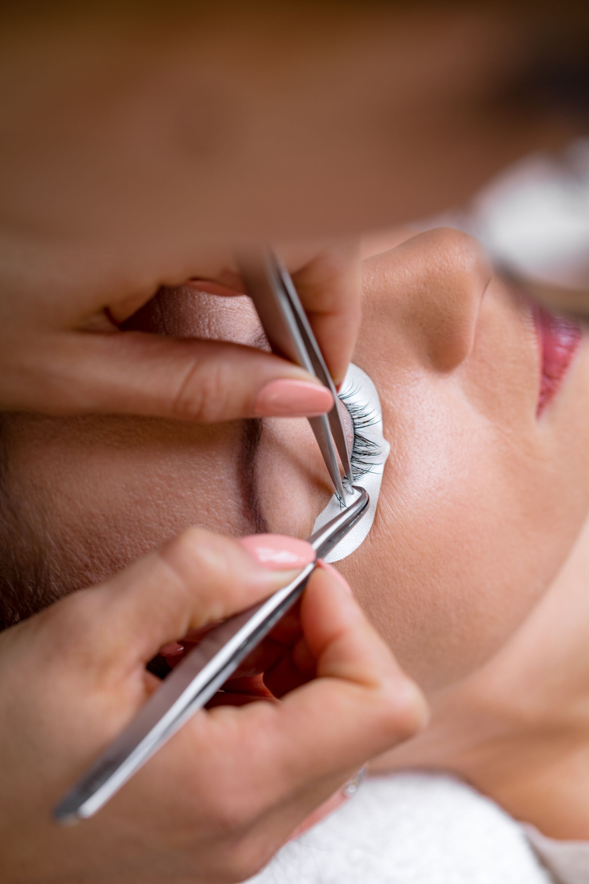 a close up of a woman getting her eyelashes done