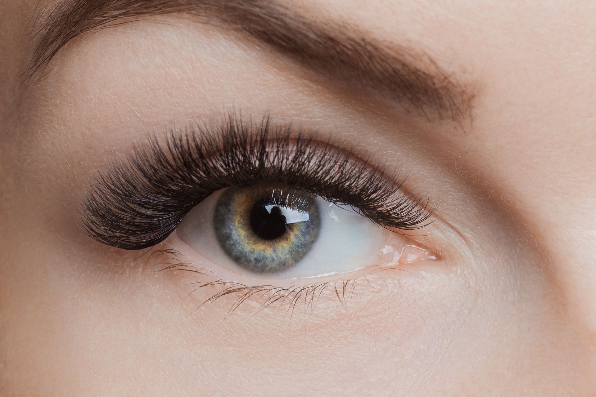 a close up of a woman's eye with long eyelashes