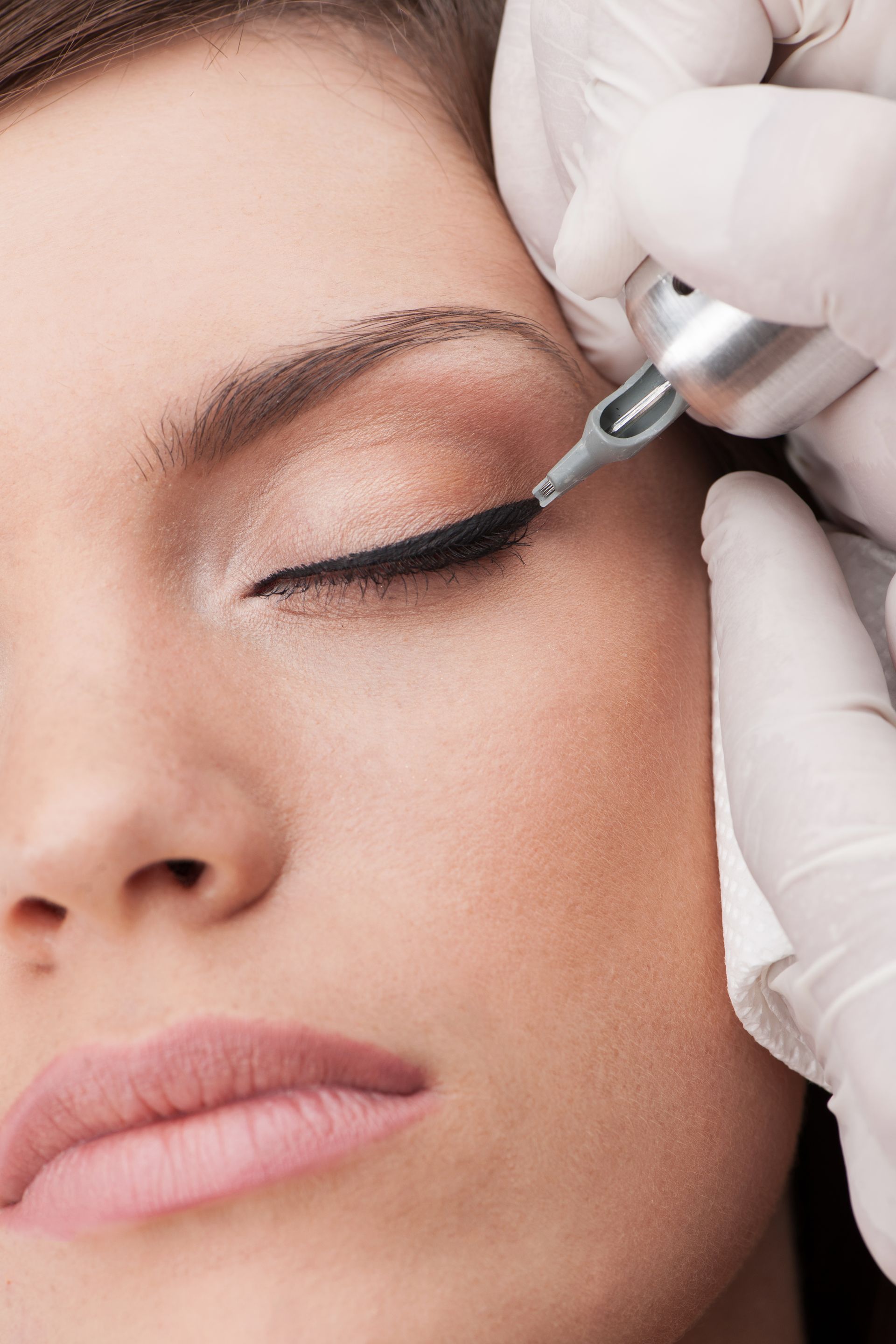 a woman is getting eyeliner tattooed on her eye