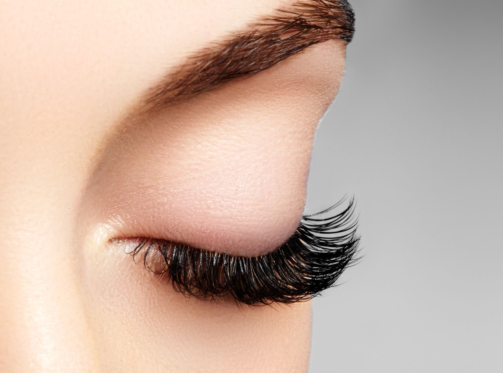 a close up of a woman's eye with long eyelashes
