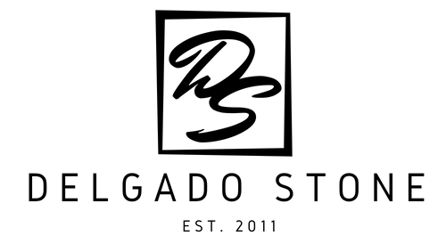 A black and white logo for a company called delgado stone.