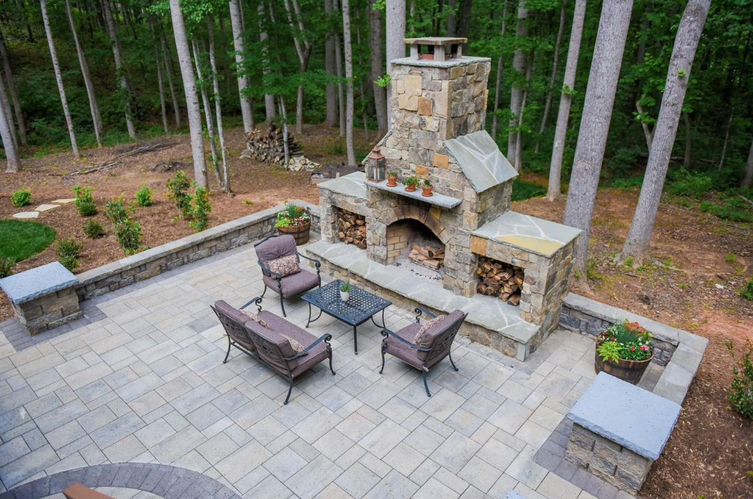 An aerial view of a patio with a fireplace and furniture.