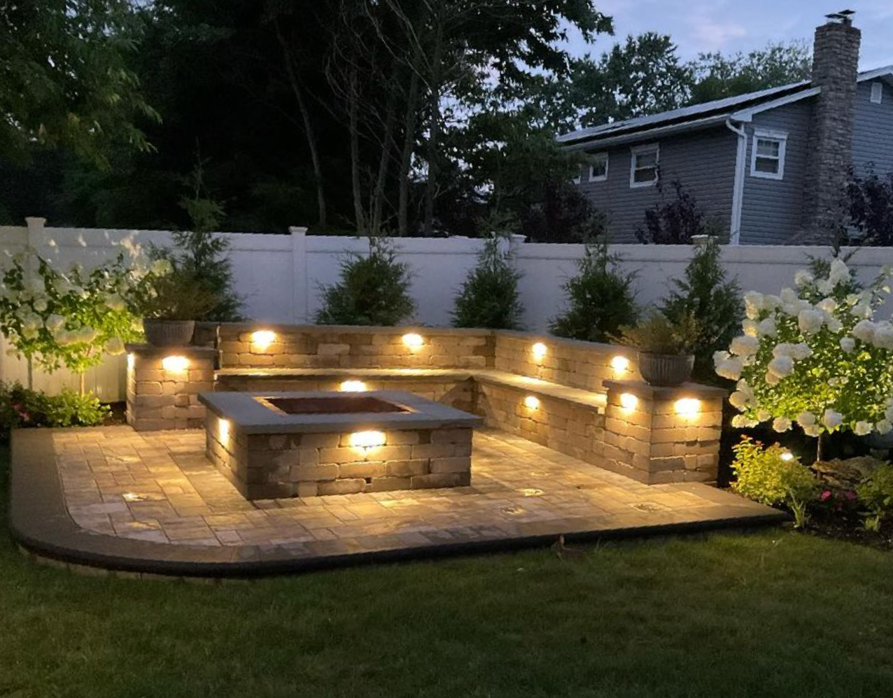 There is a fire pit in the middle of the backyard.