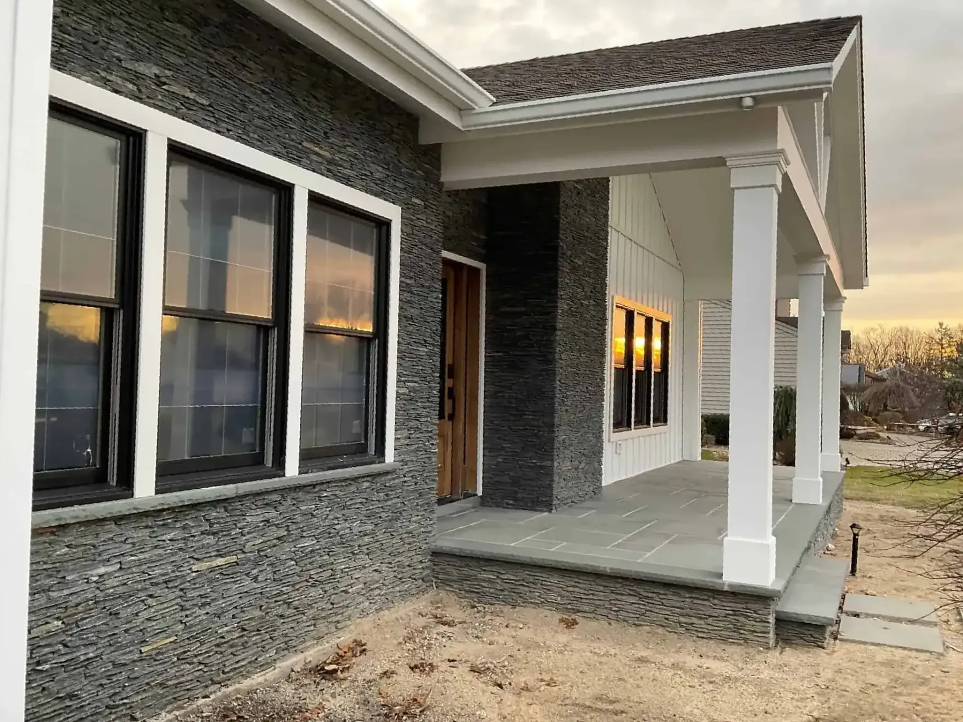 A house with a porch and a lot of windows.